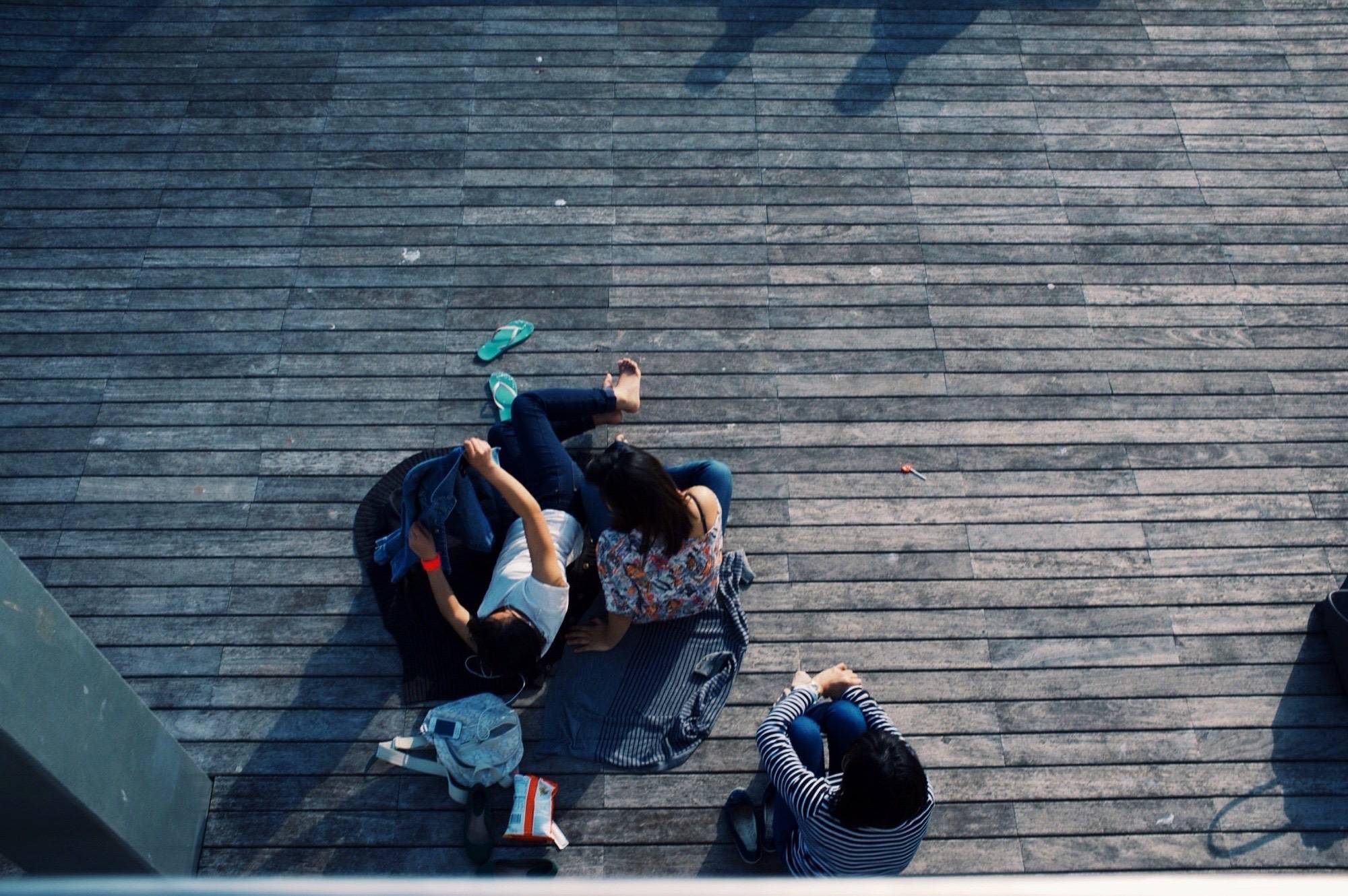 a man sitting on a bench talking on a cell phone
