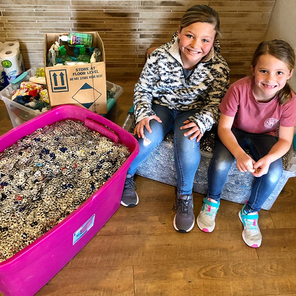 a group of people sitting in a plastic container of food